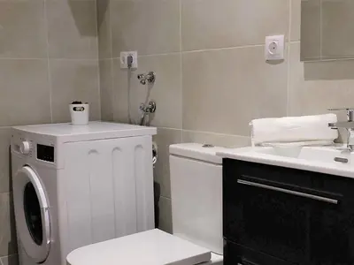 a bathroom with a washing machine and a sink at Apartment in Ourense near Thermal Baths in Ourense