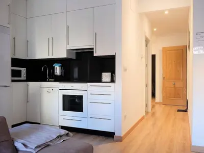 a kitchen with white cabinets and a stove top oven at Apartment in Ourense near Thermal Baths in Ourense