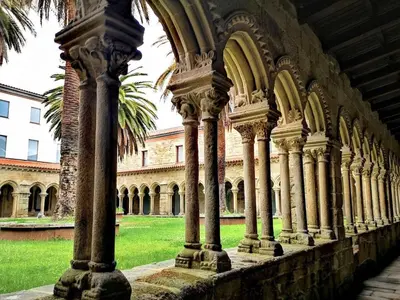 a row of columns in a building with a palm tree at Apartment in Ourense near Hot Springs in Ourense