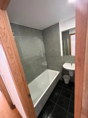 a bathroom with a bath tub and a sink at ENTRECAMIÑOS in O Pedrouzo