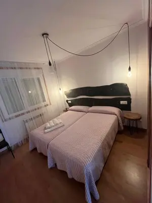 a bedroom with two beds in a room at ENTRECAMIÑOS in O Pedrouzo