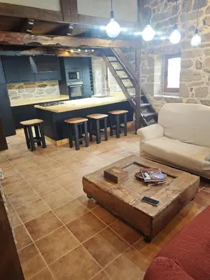 a living room with a couch and a table at CASERIO RECTORAL DESTERIZ in Ourense