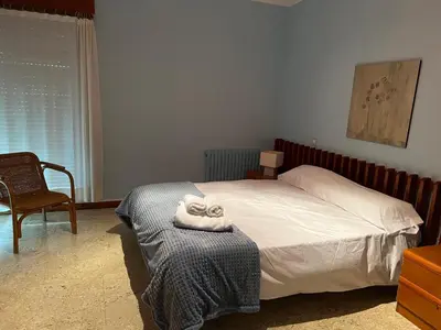 a bedroom with a bed with a towel on a table at Villa sobre el mar con acceso a la playa , ideal para familias y grupos in Ribadeo