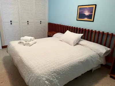 a bedroom with a bed with two towels on it at Villa sobre el mar con acceso a la playa , ideal para familias y grupos in Ribadeo