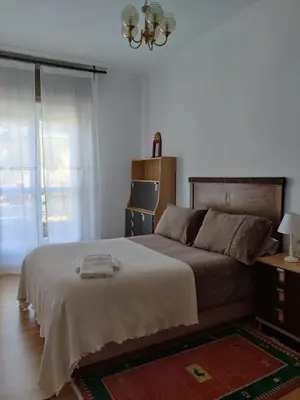 a bedroom with a large bed and a window at Casa a Trepa in Villar de Barrio