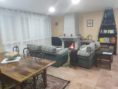 a dining room with a wooden table and chairs at Casa a Trepa in Villar de Barrio