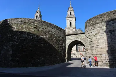 a group of people walking over a brick wall at Apartamento Calzada Romana in Lugo