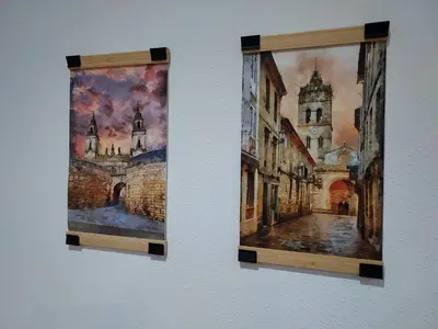 two paintings hanging on a wall at Apartamento Calzada Romana in Lugo