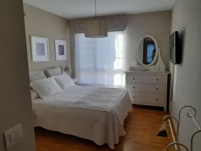 a bedroom with a bed and a dresser and a mirror at NORAY in Ribadeo