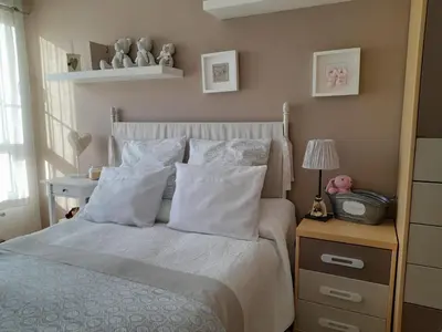 a bedroom with a bed with white sheets and pillows at NORAY in Ribadeo