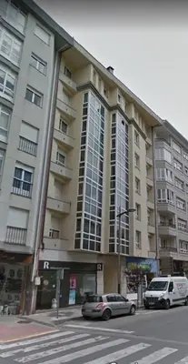 two cars parked in front of a large building at NORAY in Ribadeo