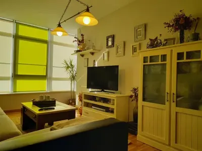 a living room with a couch and a tv at NORAY in Ribadeo