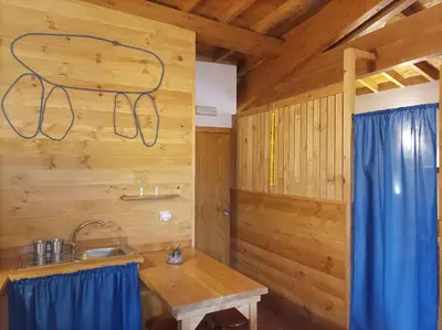a kitchen with a sink and a wooden wall at Apartamento Da Moura in Maus de Salas