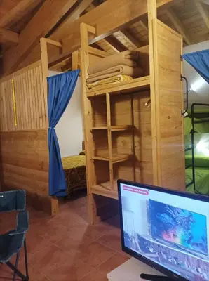 a computer monitor in a room with a bunk bed at Apartamento Da Moura in Maus de Salas