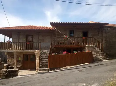 a house with a wooden fence in front of it at Apartamento Da Moura in Maus de Salas