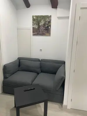 a living room with a couch and a table at Casa Triacastela in Tríacastela