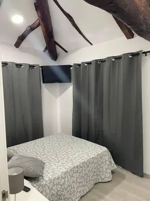 a bedroom with black curtains and a bed in it at Casa Triacastela in Tríacastela