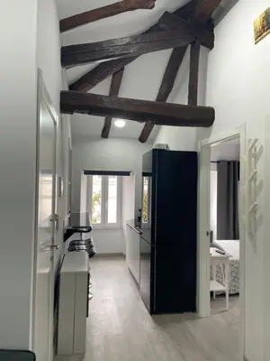 a kitchen with a black refrigerator in a room at Casa Triacastela in Tríacastela