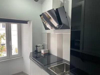 a kitchen with a sink and a window at Casa Triacastela in Tríacastela