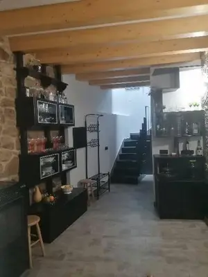 a room with stairs and a room with tables and chairs at Casiña da Madalena in Ribadavia