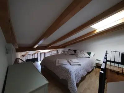 a bedroom with a bed with two towels on it at Casiña da Madalena in Ribadavia