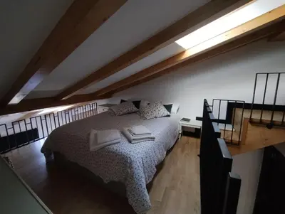 a bedroom with a bed with two books on it at Casiña da Madalena in Ribadavia