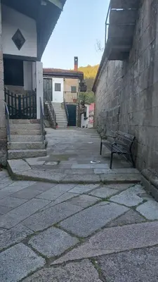 a bench sitting in front of a building with stairs at Casiña da Madalena in Ribadavia