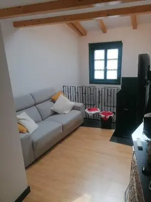 a living room with a couch and a television at Casiña da Madalena in Ribadavia