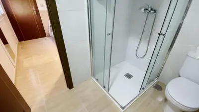 a bathroom with a shower and a toilet at Hostal Restaurante Cuatro Caminos in Cubillos del Sil
