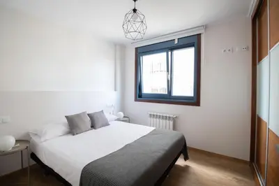 a bedroom with a white bed and a window at Mar de Sada in Sada