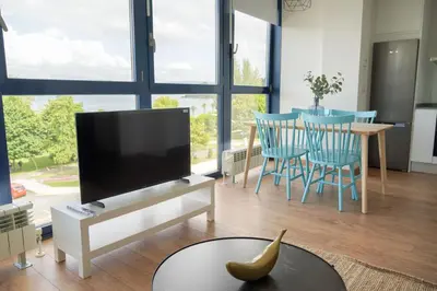 a living room with a television and a banana on a table at Mar de Sada in Sada