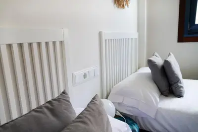 a bedroom with two beds with pillows on it at Mar de Sada in Sada
