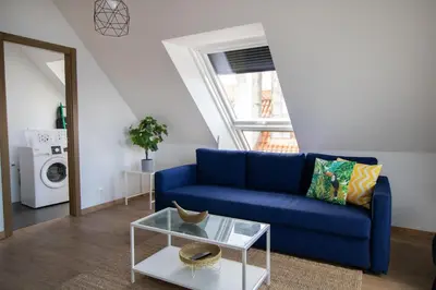 a living room with a blue couch and a table at Mar de Sada in Sada