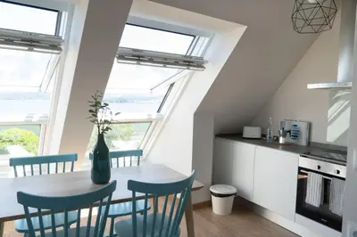 a kitchen and dining room with a table and chairs at Mar de Sada in Sada