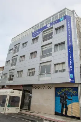 a building with a painting of a man on it at Albergue Turístico Silleda in Silleda