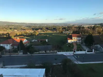 a view of a town with houses and a street at Albergue Turístico Silleda in Silleda