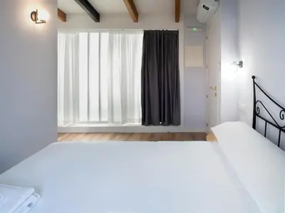 a bedroom with two beds and a large window at Casa do cabo in Arzúa