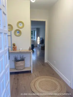 a living room with a hallway with a mirror at Villa Mauro Ribadeo Apartamento Turístico in Ribadeo