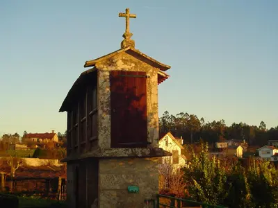 an old church with a cross on top of it at Hostal Boavista in Costoia