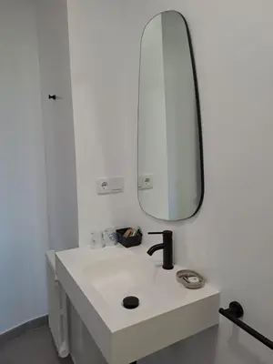 a white bathroom with a sink and a mirror at Hostal Boavista in Costoia