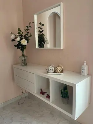 a white shelf with a mirror and a vase of flowers at Alojamiento Apostol 2 in Melide