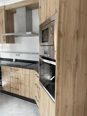 a kitchen with a stove and a microwave at Alojamiento Apostol 2 in Melide