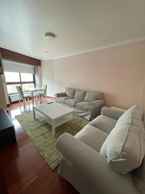 a living room with a couch and a table at Alojamiento Apostol 2 in Melide