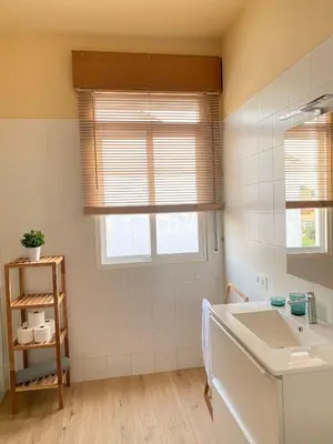 a bathroom with a sink and a window at Casa Morín, apartamento Ribeira Sacra in Monforte de Lemos