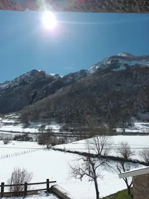 a snow covered field with a mountain in the background at Hotel valle de lago in Valle de Lago