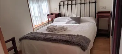 a bedroom with a bed with towels on it at Hotel valle de lago in Valle de Lago