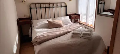 a bedroom with a bed with two towels on it at Hotel valle de lago in Valle de Lago