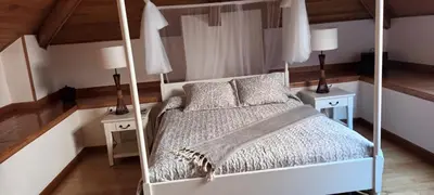 a bedroom with a canopy bed with two night stands at Hotel valle de lago in Valle de Lago