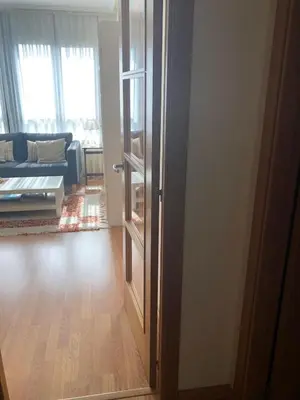 an open door to a living room with a couch at Apartamento para 6 personas con piscina y paddle in Foz