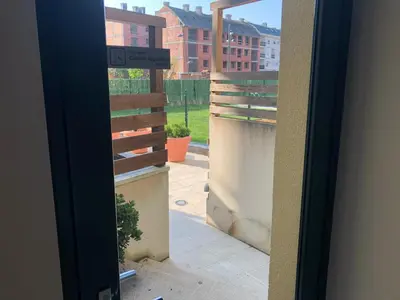 a door to a balcony with a view of a yard at Apartamento para 6 personas con piscina y paddle in Foz